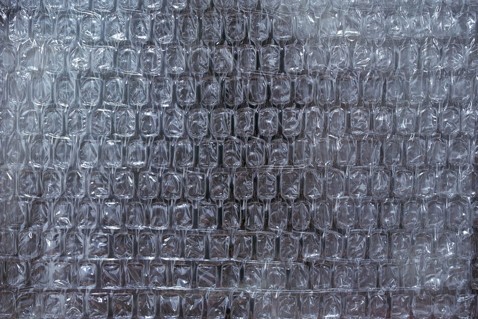 A sheet of clear plastic bubble wrap filling the frame, backed by a dark surface