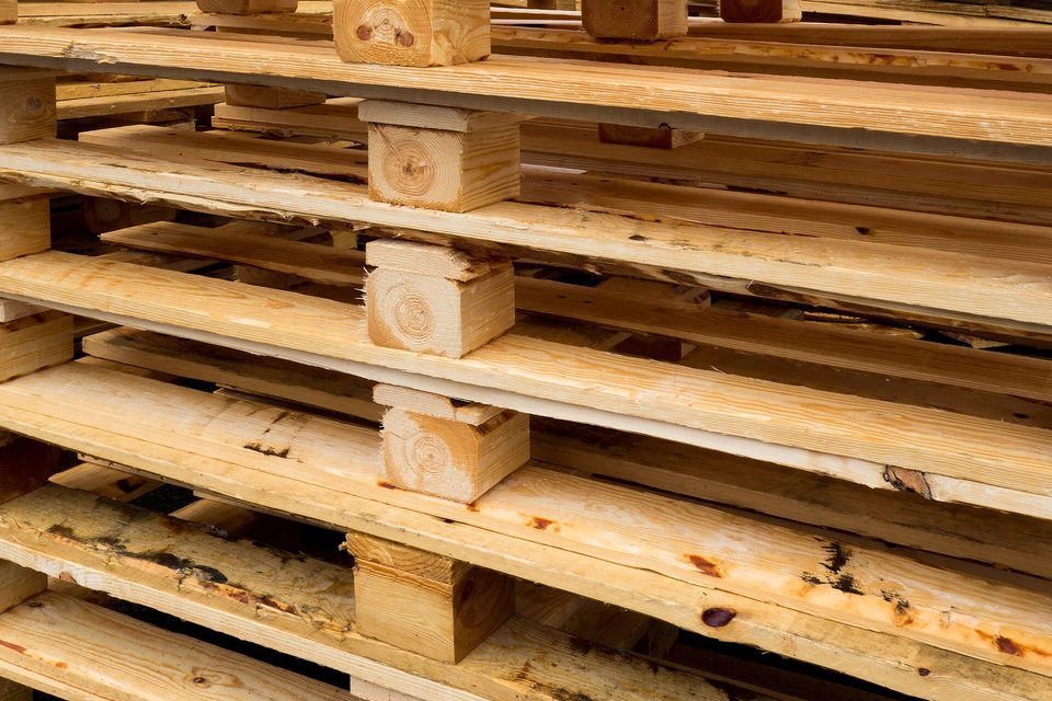 A close view of wooden shipping pallets stacked one on top of another